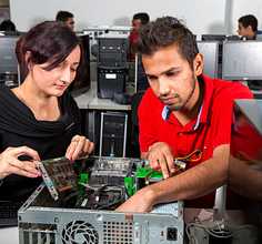 Two students repairing a computer